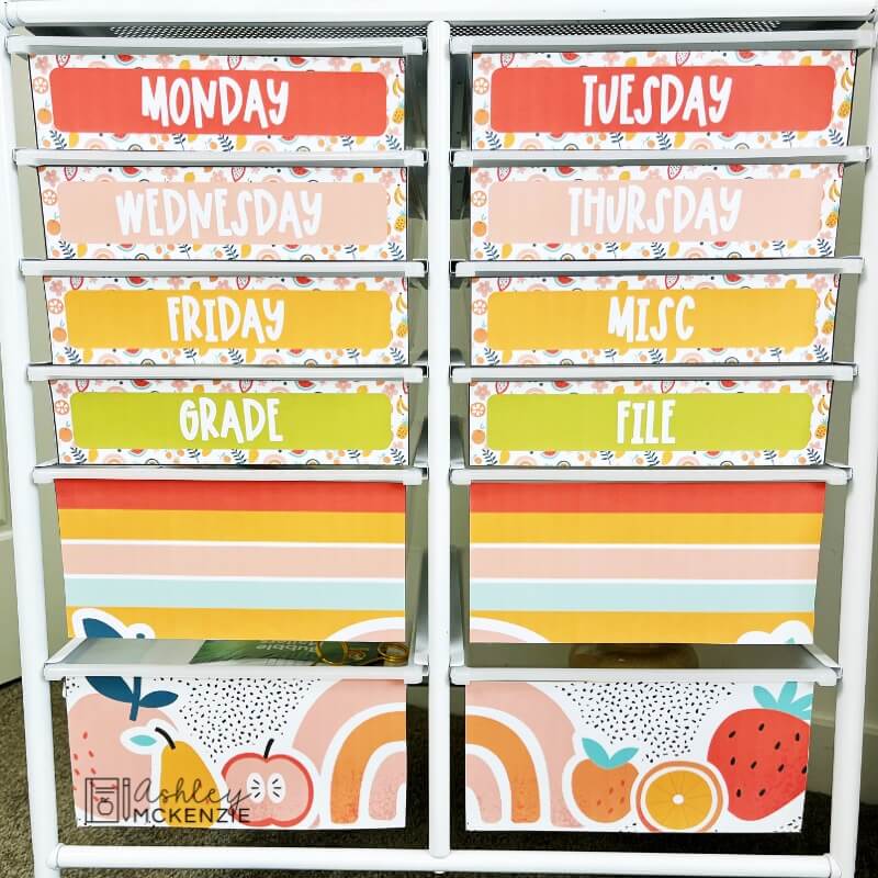 Bright fruit themed rolling cart labels are displayed on a 12 drawer rolling cart in a classroom.