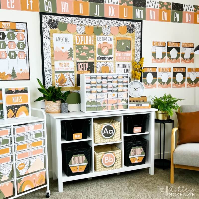 A classroom decorated for back to school in a camping adventure theme, featuring a white storage shelf.