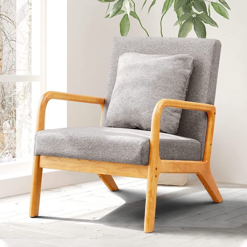 A wooden frame reading chair with gray padding.