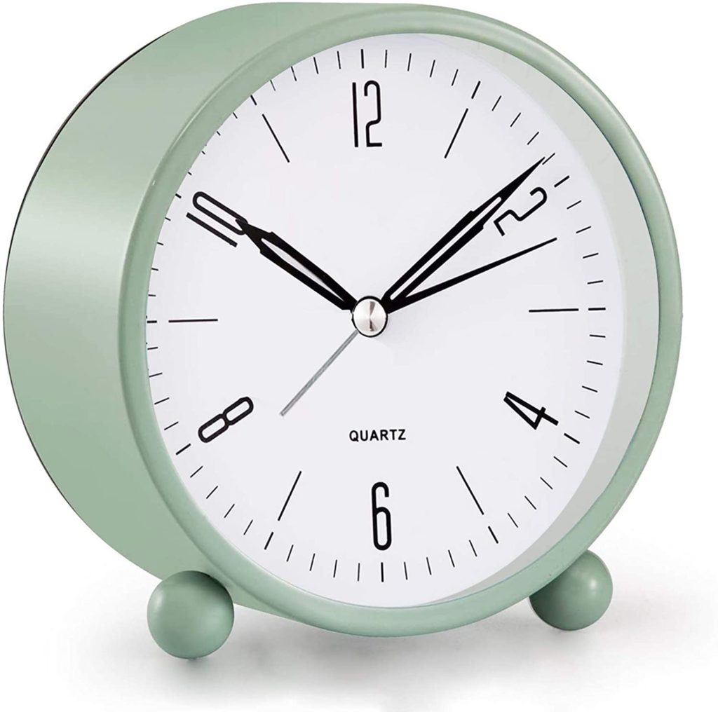 Classic desk clock in a light green color with simple clock face.