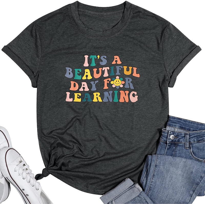 A retro inspired t-shirt that says "It's a beautiful day for learning" in colorful letters.