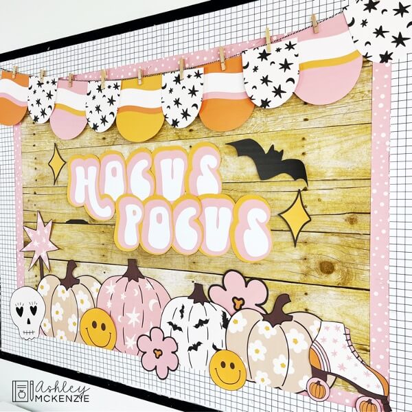 A classroom bulletin board decorated with retro Halloween style themed decor. The saying Hocus Pocus is displayed including pumpkins, roller skates, and festive banners.