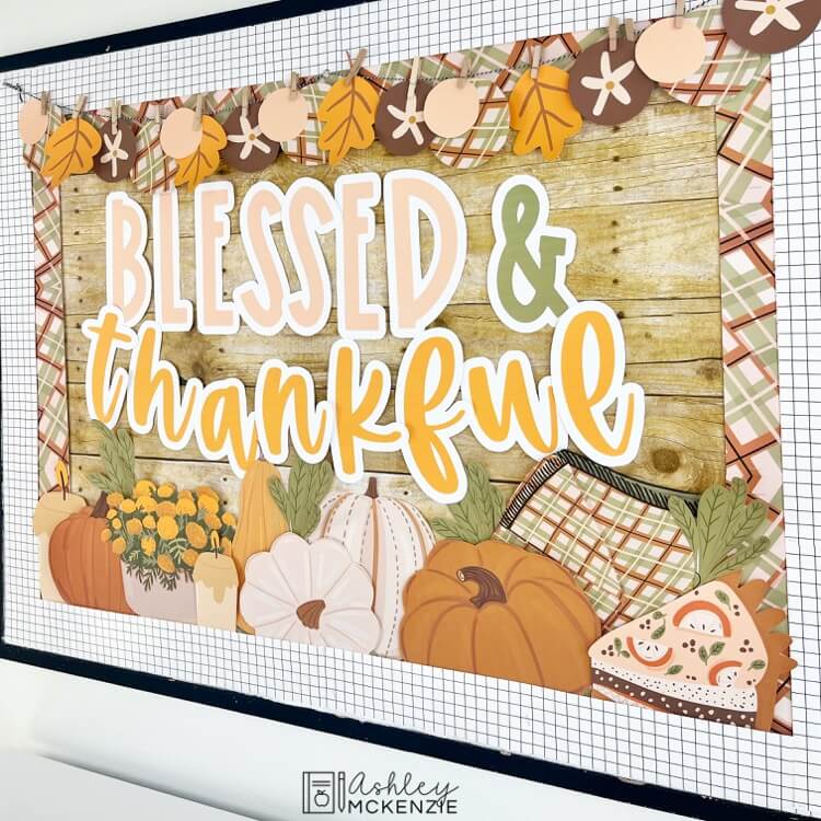 A classroom bulletin board featuring the saying "Blessed and Thankful." Harvest themed decor including pumpkins, candles, fall flowers, and plaid patterns are shown.