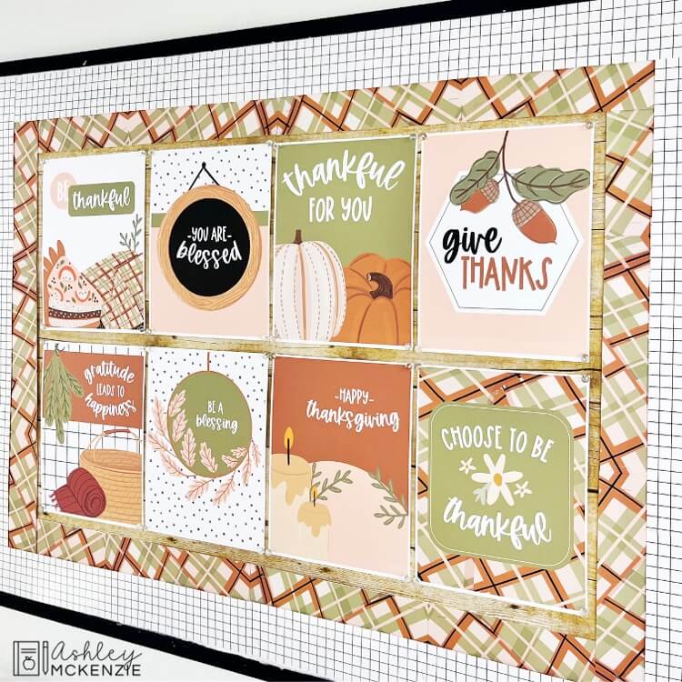 Modern Thanksgiving themed classroom posters are displayed on a classroom bulletin board. There's a modern plaid border and a black and white window pane border on the outside.