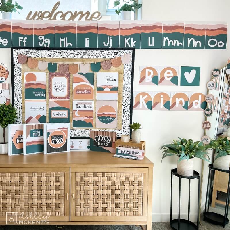 A classroom decorated with uplifting posters including a large wall display that says "Be Kind"