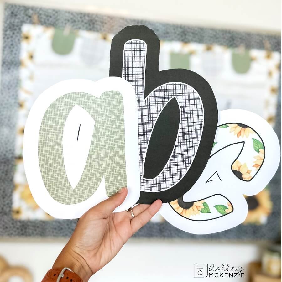 Cutouts of lower case letters a, b, and c in a primary friendly font are shown featuring fall sunflowers themed patterns.