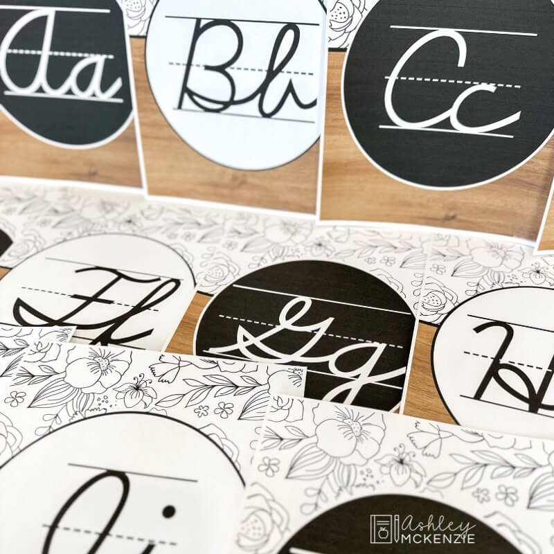 Alphabet posters featuring a cursive font and black and white designs