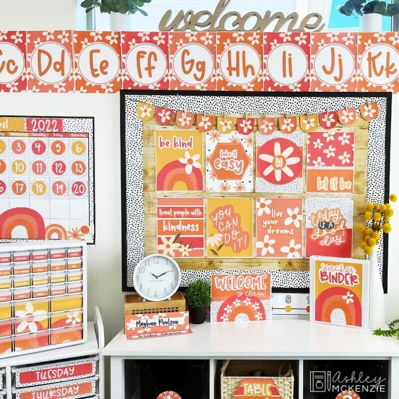 A classroom decorated with a bright, cheerful daisy classroom decor theme including alphabet posters, a wall calendar, and bulletin board displays