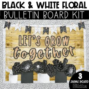 A classroom bulletin board decorated with black and white back to school bulletin board kit decorations featuring floral images and the saying "Let's grow together"