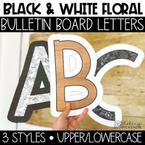 Black and white bulletin board letters featuring floral designs and wood grain accents