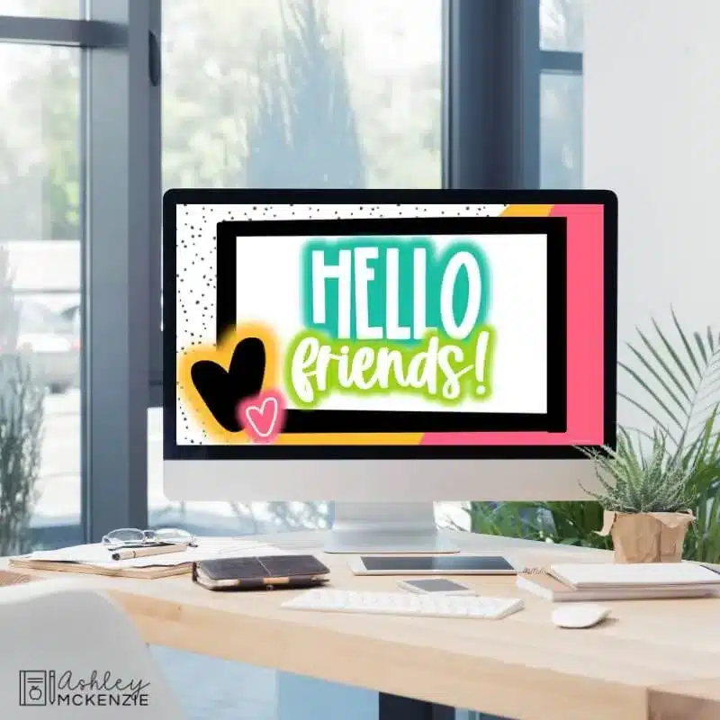 A classroom computer is shown displaying Google Slides templates that say "Hello Friends" featuring a neon themed design