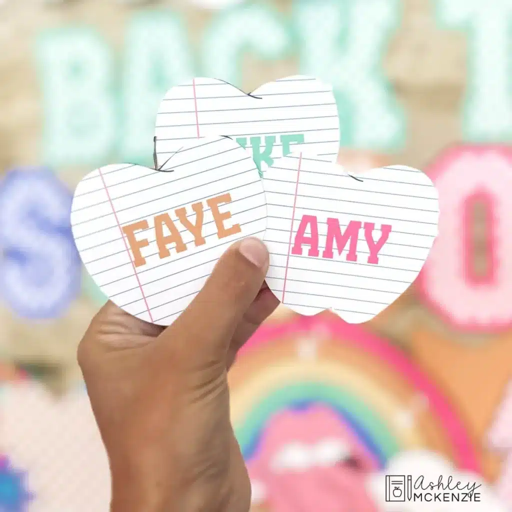 Apple cutouts are shown with students' names typed on them to display on a classroom bulletin board