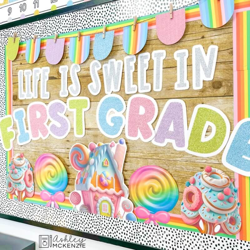 Back to school classroom decor featuring a colorful bulletin board display with the saying "Life is sweet in first grade"