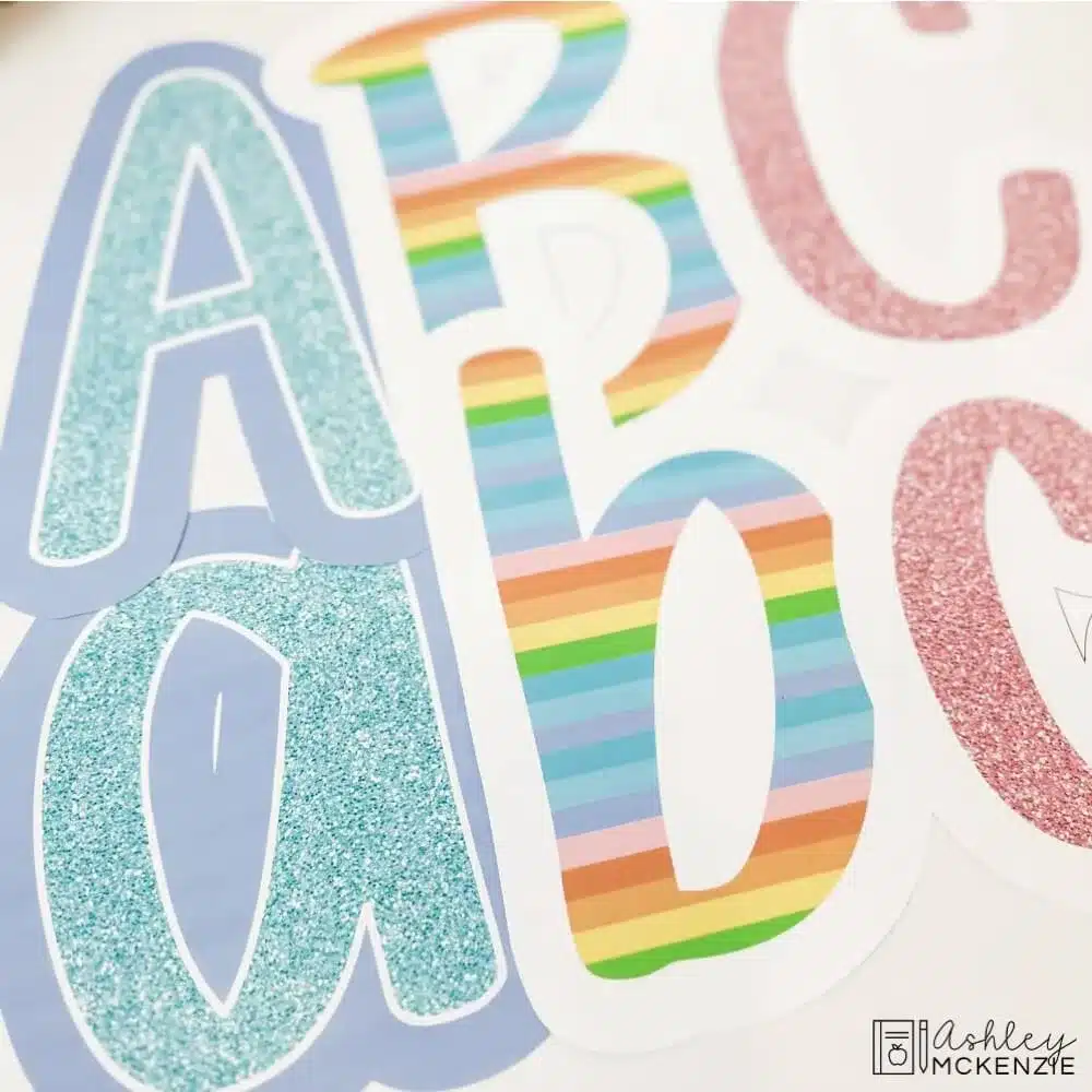 Bulletin board letters in a primary friendly font featuring colorful pastel designs with glittery texture 