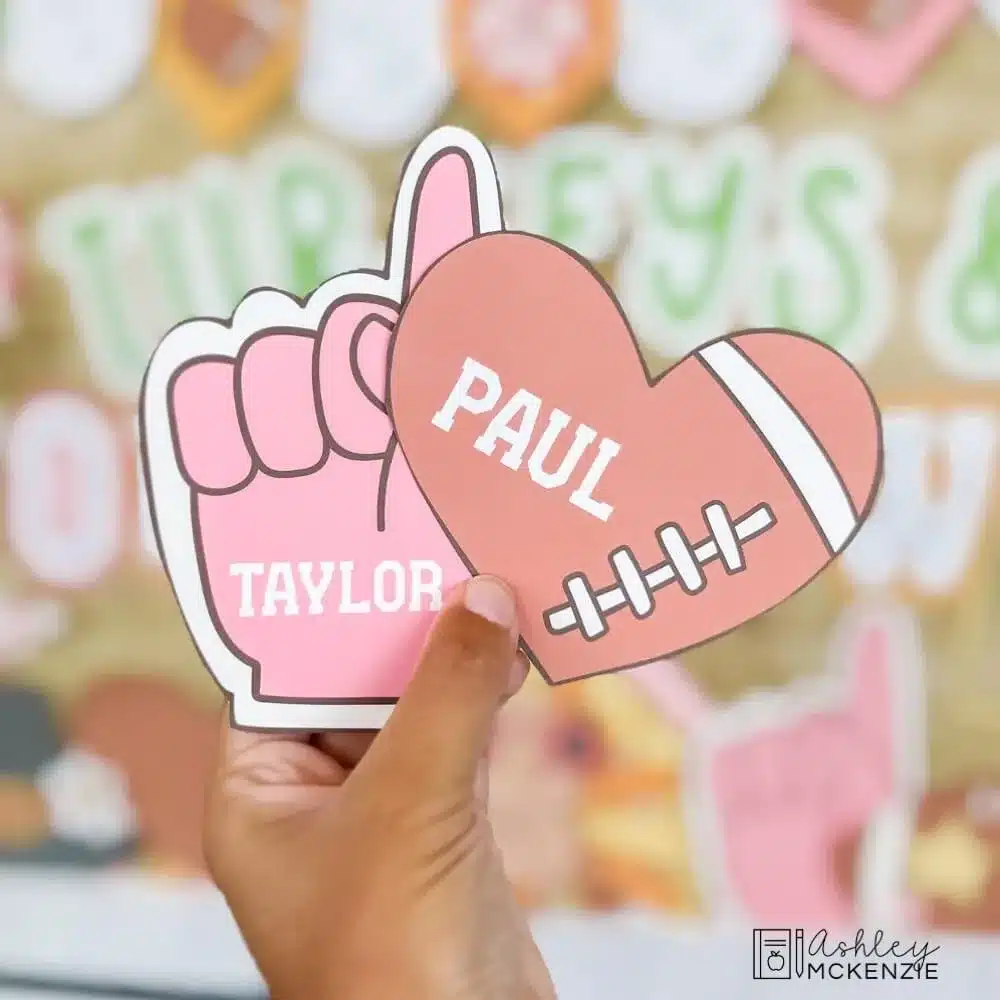 Football bulletin board cutouts are shown featuring student names printed on them in the shape of a foam finger and a heart-shaped football