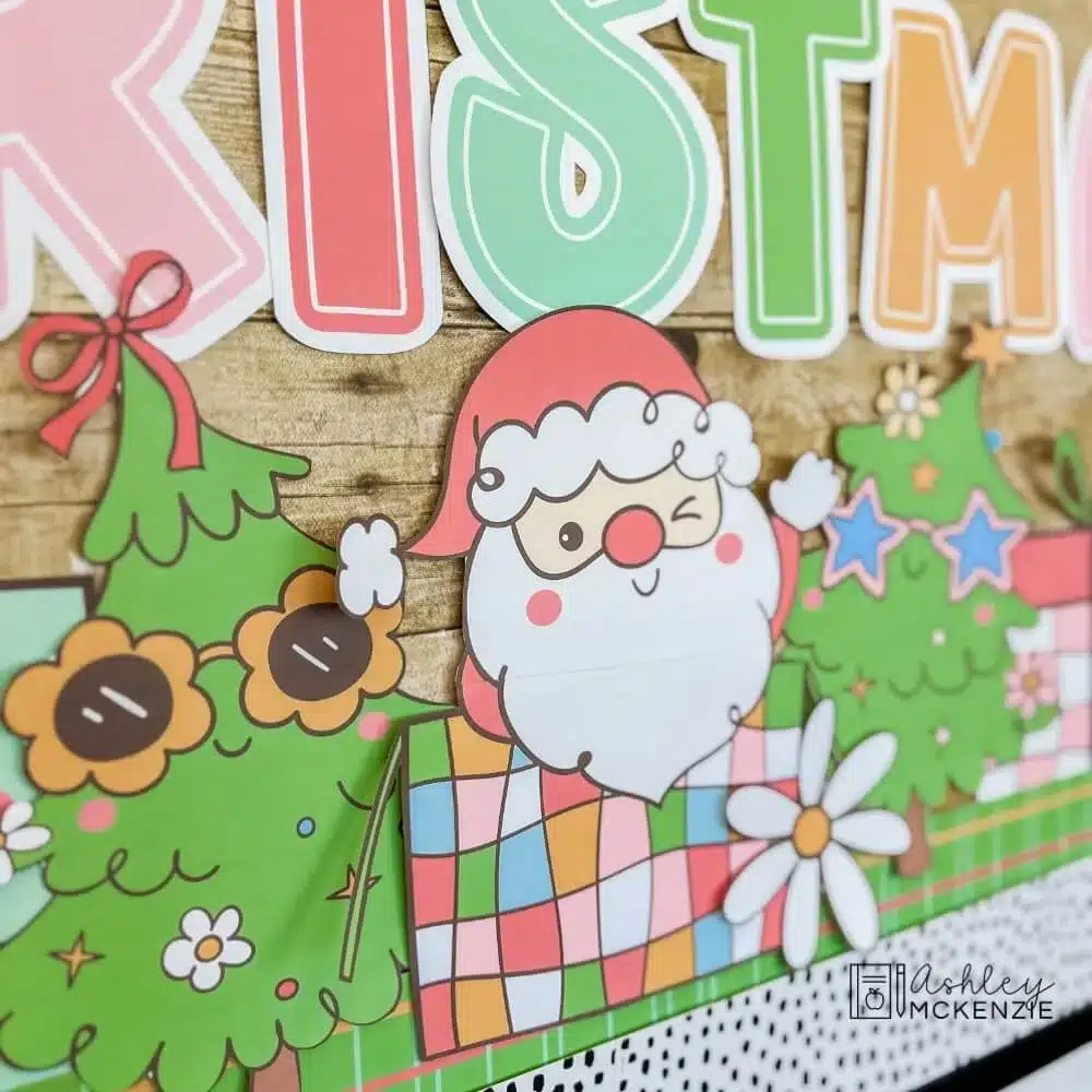 A closeup of a Christmas bulletin board decor cutouts including a Santa and two evergreen trees wearing sunglasses