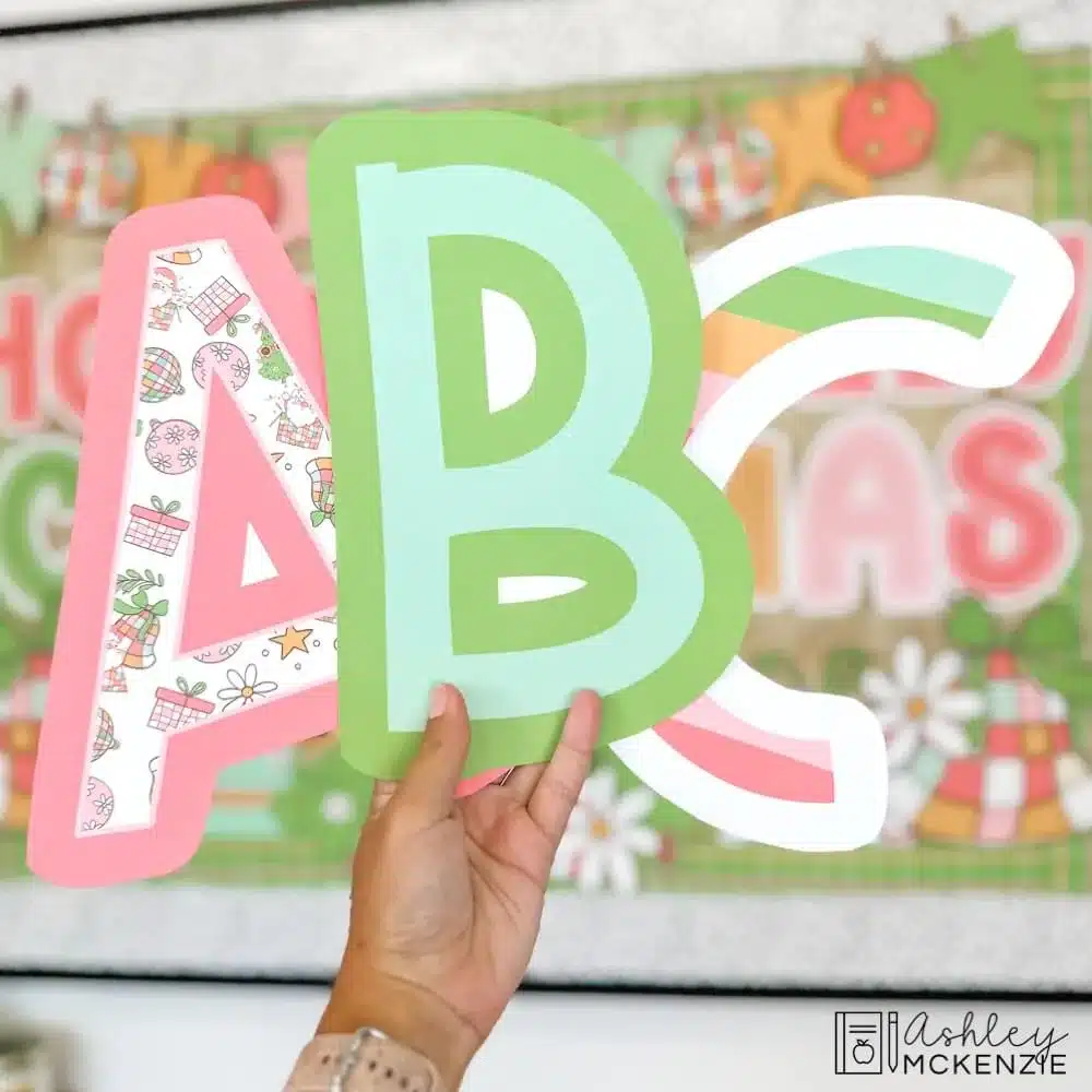 3 large bulletin board letter cutouts are shown featuring Christmas themed prints and colors