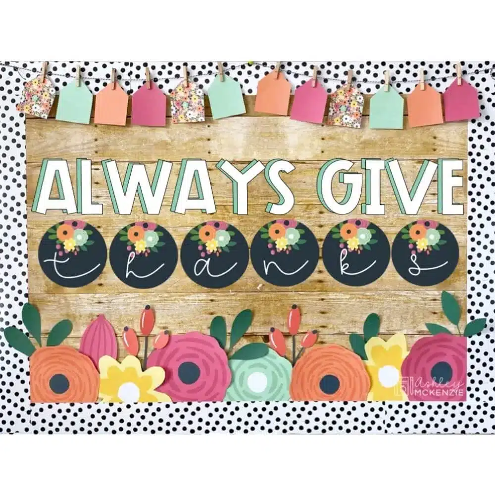 A Thanksgiving themed bulletin board display featuring florals and the saying " Always Give Thanks"