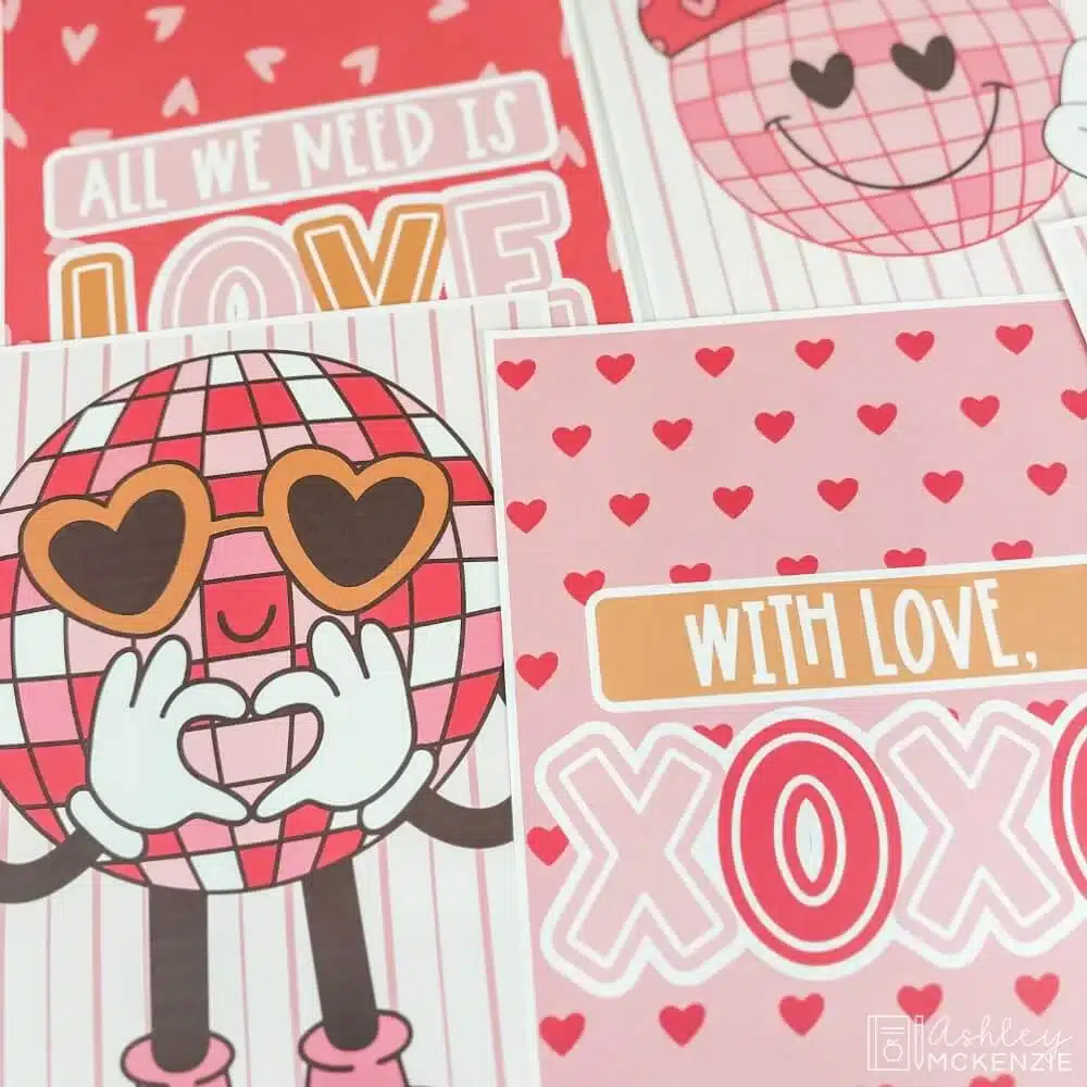 A closeup of Valentine's Day posters featuring a disco ball in Valentine's colors and a poster that says "With love, XOXO"