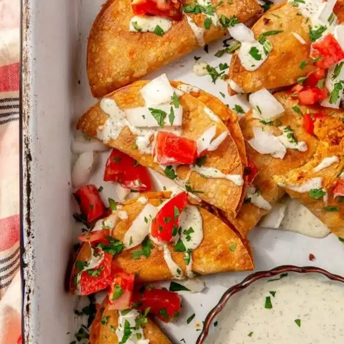 Crispy tacos shown in a baking dish