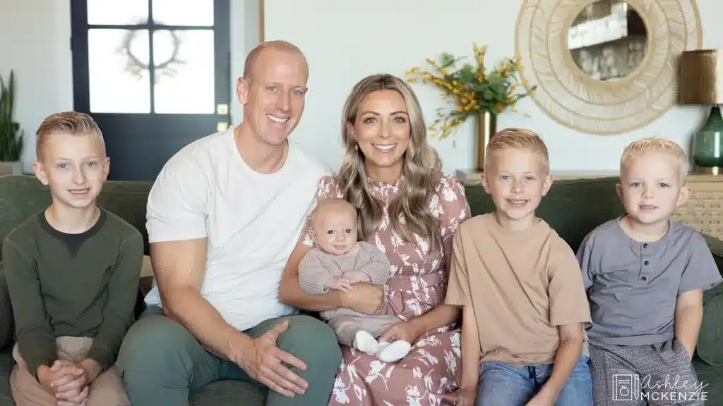 A family sitting on their couch smiling