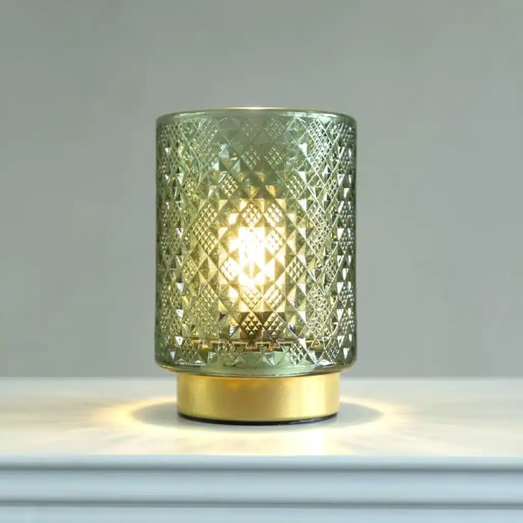 A lamp with a soft warm glow set on a counter top