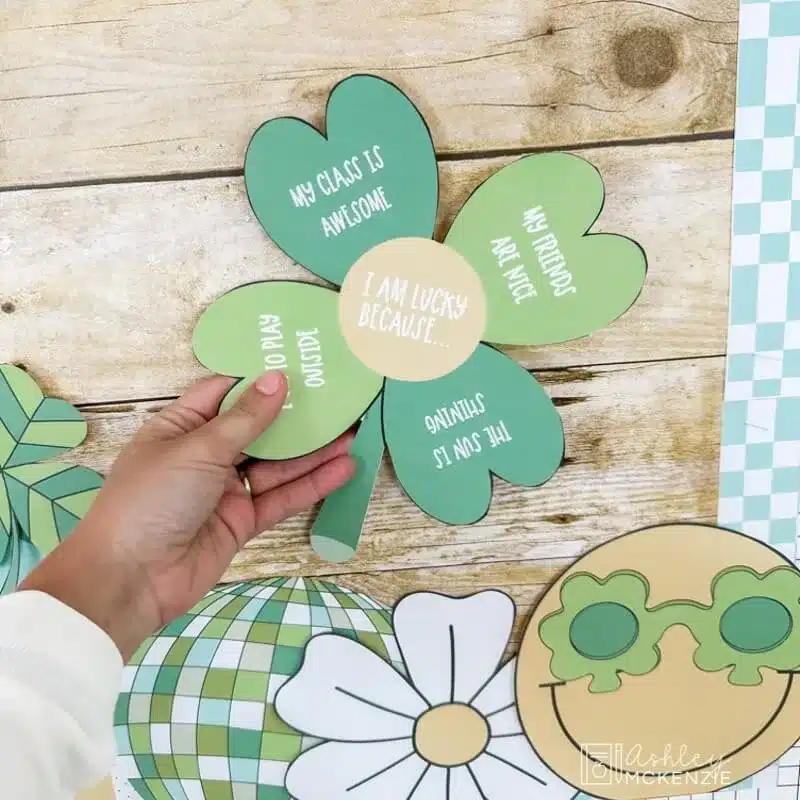 St. Patrick's Day bulletin board shown with a 4 leaf clover cutout that students' share reasons why they're lucky on