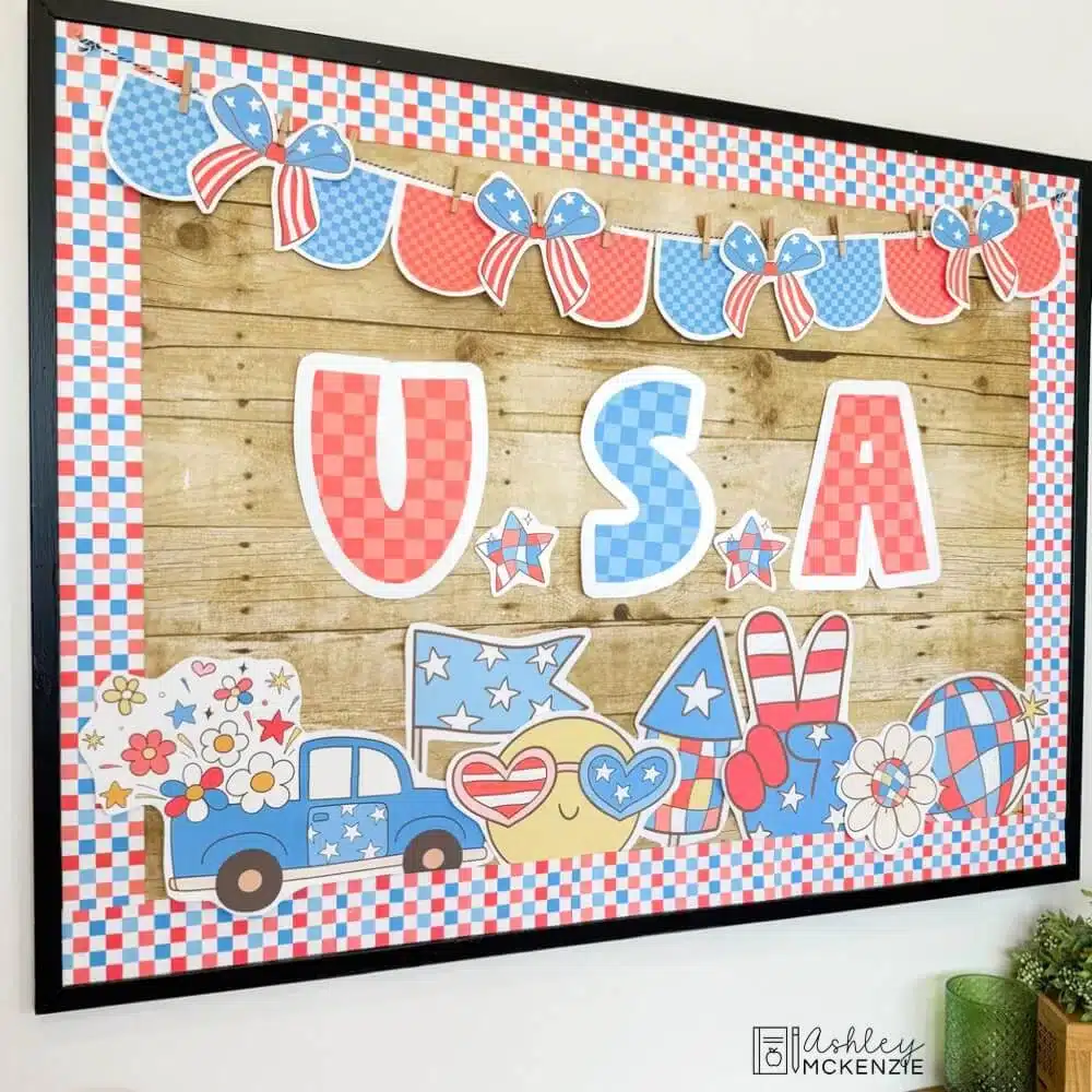 A classroom 4th of July bulletin board decorated with a patriotic theme and letters that spell "USA."