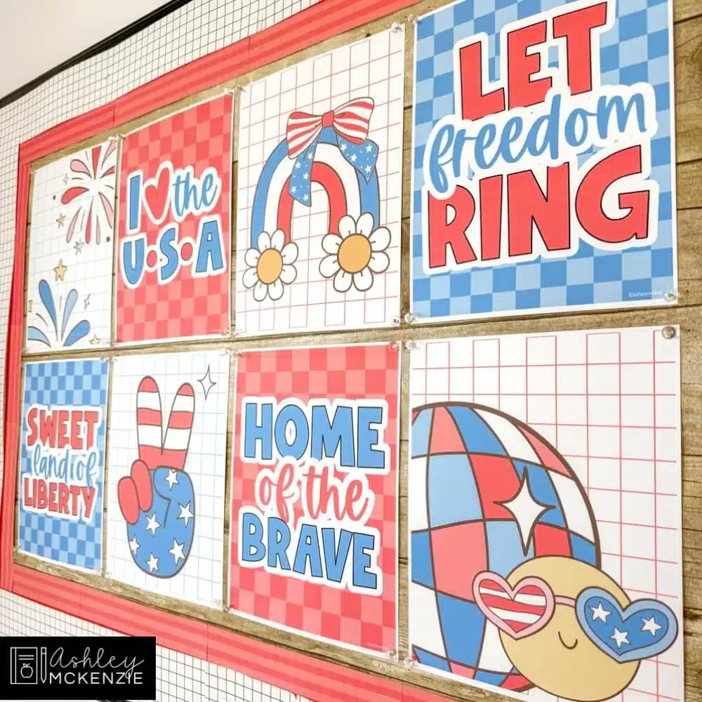 A 4th of July bulletin board decorated with vibrant classroom posters featuring red, white, and blue designs.