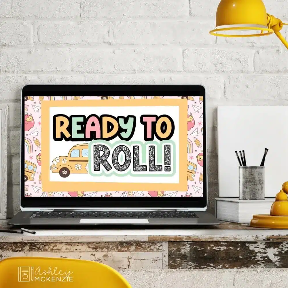 A classroom computer displaying a colorful back to school Slide Template that reads "Ready to Roll"