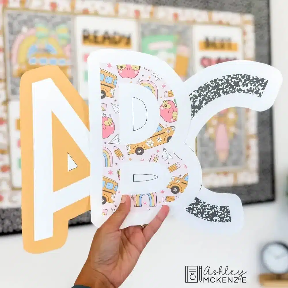 Uppercase bulletin board letters A, B, and C are shown in 3 unique patters like yellow, school supplies pattern, and black composition notebook cover.