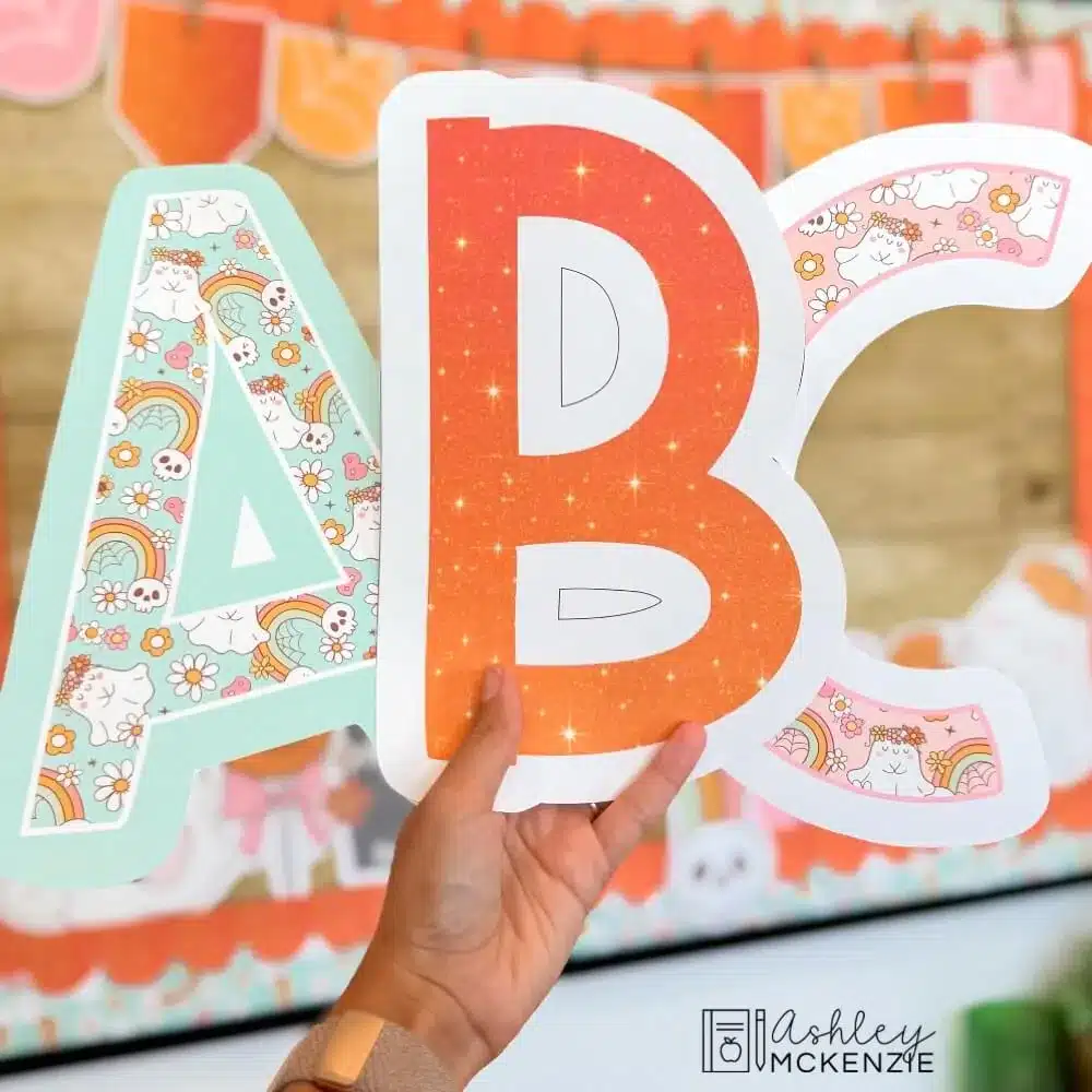 Halloween bulletin board letters A, B, and C are shown featuring different prints including a sparkly orange design, and a friendly cartoon ghosts pattern